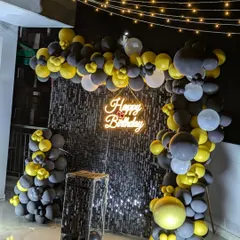 An angled view showing the depth of the balloon arch against the shimmering sequin wall, perfect for night-time celebrations.