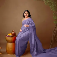 This unique saree draping style creates a long, flowing train, adding a touch of modern drama to a traditional look.