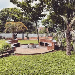 I designed this circular brick fire pit and seating area as the heart of a sprawling farmhouse landscape. It’s a perfect example of creating a warm, inviting social hub for family and friends to gather, surrounded by mature trees and open green space.