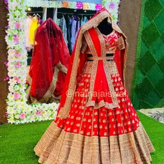 A full view of a stunning red bridal lehenga, featuring a belted dupatta style. This shows how we can style the same outfit in different ways for various functions.