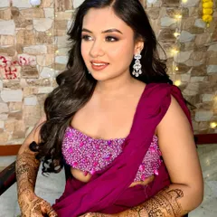 My pretty Mehendi bride in a vibrant magenta outfit. The makeup is soft and glamorous, with a neutral eye and a warm lip color to balance the bright ensemble.