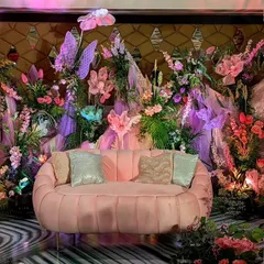 I brought a whimsical fairytale to life for this Sangeet stage. The design features a soft pink couch set against a backdrop of sculpted florals and oversized, magical butterflies, creating a playful yet theatrical atmosphere for a night of celebration.