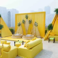 This is the complete rooftop Haldi setup, featuring the main stage, guest seating, and photo corners. I designed the layout to make the most of the open space against the city skyline.