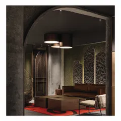 From the foyer, one enters a mock-up living space within the 'Frozen' retail store. A chestnut leather sofa and a raw, burnt log bench are set against a moss-like wall texture, creating a surprising and earthy vignette within the larger zen-inspired design.