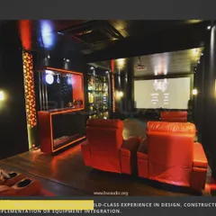 This project features a custom-designed bar and display cabinet integrated directly into the home theater. The red LED lighting connects the two spaces, creating a cohesive and stylish entertainment zone.