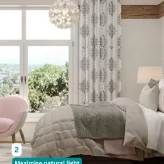 Maximizing natural light is crucial for a spacious feel. We kept the furniture minimal and used light-colored curtains to ensure this bedroom feels bright and airy.