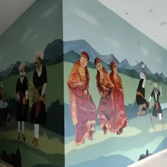 For a clubhouse in Coorg, I painted a large-scale mural celebrating the local Kodava culture and festivals. This section depicts the Puthari harvest festival, with detailed figures of men and women in traditional attire.