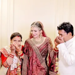 Capturing the playful side of family relationships is something we truly enjoy. Here, a bride shares a fun, lighthearted moment with her parents, showcasing their unique bond.