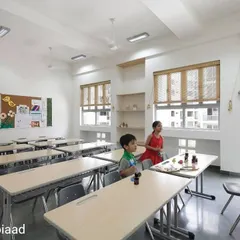 Based on the ideologies of Sri Aurobindo, the classrooms at Matrikiran School are designed to nurture individual growth. The space is filled with natural light from large windows with bamboo blinds, and the layout encourages interaction and participation among students.