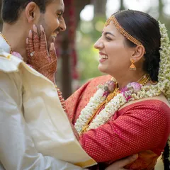 In this candid moment, you can see how the drape allows for natural movement and comfort. The bride's red silk wedding saree is draped to perfection, staying in place even during the most emotional and happy interactions.