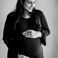 There is a timeless beauty in black and white photography. This classic maternity portrait focuses on the mother's gentle smile and the beautiful curve of her bump.
