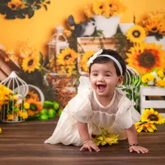 A crawling shot amidst a field of sunflowers. This dynamic photo captures the joy and energy of a one-year-old on the move.