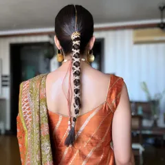 A detailed shot of the traditional braided hairstyle we created for Aaliyah Kashyap's Mehendi. The intricate weaving and accessories are a key part of the complete look.