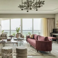 A closer look at this stylish haven, where modern aesthetics meet comfortable seating. The room features a mix of plush sofas, unique accent chairs, and lush greenery, creating a perfect setting for gatherings.