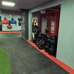 Our gym is stocked with professional-grade equipment, including grappling dummies for ground-and-pound drills and protective gear for safe sparring.