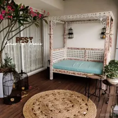 We believe every home needs a corner for peace. This balcony was transformed with an ornate daybed, potted plants, and soft lighting to create a perfect, cozy spot for rest.