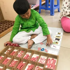 The Moveable Alphabet is where children first experience the magic of writing. They use these wooden letters to build words and sentences, expressing their own thoughts long before their hands are ready to hold a pencil perfectly.