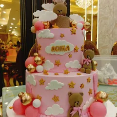 A dreamy two-tier cake for a special birthday, featuring adorable teddy bears, a hot air balloon, and fluffy clouds. We love working on detailed themes like this to create a centerpiece that tells a story.
