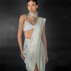 A three-quarter shot from the Nikhil Thampi lookbook. This angle provides a clear view of the outfit's silhouette and the statement pearl choker, essential for a designer's catalogue.