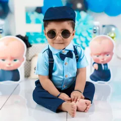 The "Boss Baby" has arrived! This little one looks cool and confident in his sunglasses and suspenders, ready for his first birthday celebration.