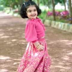 A happy twirl in the park. We capture these candid, joyful moments during our outdoor kids photography sessions.