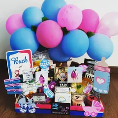 Buck or Doe? This gender reveal hamper is filled with snacks and decorated with pink and blue balloons and signs. It's a fun way to build excitement for the big reveal.