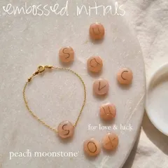 I love creating pieces that are deeply personal. Here you can see how I hand-emboss initials onto a pebble-shaped Peach Moonstone, a stone known for attracting abundance and good fortune in love. It makes for a truly meaningful gift.