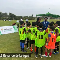 A coach giving a pre-match talk to our U11 team during the Reliance Jr League. Tactical instruction is a key part of our program.