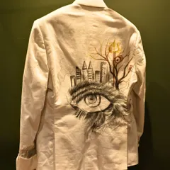 This jacket features a surrealist hand-painted design, blending a cityscape with an artist's eye. It is a bold expression of individuality, crafted for the man who sees his clothing as a canvas.
