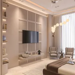 A cozy bedroom design featuring limewash walls and classic paneling. The built-in shelving and comfortable reading chairs create a functional and elegant space for relaxation.