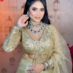 This pose highlights the beautiful diamond and emerald necklace. The makeup is kept elegant to balance the heavy jewelry.