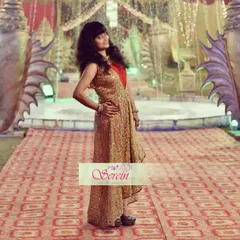 A client looking chic in a custom-designed high-low jacket paired with a jumpsuit. The golden brocade jacket adds a touch of glamour, making this a perfect Indo-western outfit for a wedding party.