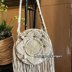 A variation of our round macramé bag in an off-white color. It’s a timeless piece that pairs well with everything, perfect for a day out or a beach vacation.