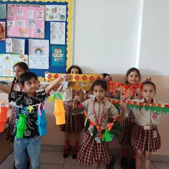 Campers hold up the decorative 'torans' and lanterns they made. Our art and craft curriculum is designed to be both educational and fun, resulting in beautiful keepsakes that children are proud to take home.