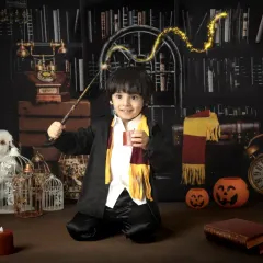 A young wizard casts a spell with a magical light trail effect. My themed sessions include creative editing to add an extra layer of fantasy.