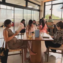 Readers finding their cozy corners at our Sip & Read event. It’s a chance to disconnect from your phone and reconnect with a good book and good company.