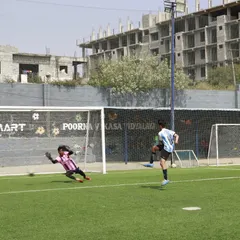 A goalkeeper makes a diving save during a trial match. Our trials are designed to identify talent and assess a player's performance in a high-stakes environment.