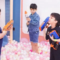 Kids engage in a friendly blaster battle in the safety of our soft and spacious ball pit.