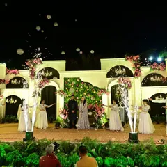 The reception stage comes to life with the couple's entry, complete with dancers and cold pyro effects. The design provides a grand yet elegant setting for the evening's celebrations.