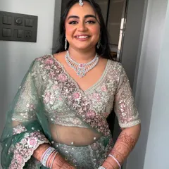 A full-length view of Vrushali's stunning engagement outfit. The makeup is fresh and elegant, letting her happiness and the beautiful details of her lehenga shine.