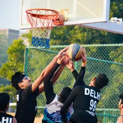 Three players go up for a rebound in this action-packed shot. Moments like these highlight the importance of positioning, timing, and determination under the basket.