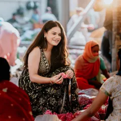 Another genuine moment from the flower market shoot. The bride's smile is radiant as she engages with the vibrant surroundings.