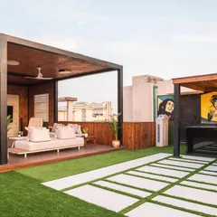 The terrace includes a custom bar and barbecue area, perfect for hosting parties. The quirky art adds a pop of color and personality, making the space feel fun and unique.