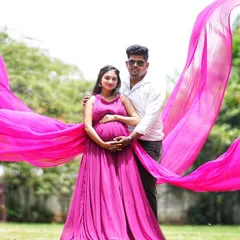 Celebrate your special journey with my collection of maternity photoshoot gowns. This flowing magenta dress with a long trail is designed to be comfortable while creating beautiful, ethereal portraits of you and your bump.