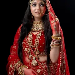 A detailed close-up of the Padmavathi look, highlighting the intricate headpiece, nose ring, and embroidered red lehenga, available for rent for your royal-themed shoot.
