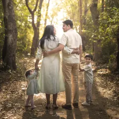 A walk in the woods becomes a beautiful memory. This outdoor family session captures the feeling of adventure and togetherness as they explore the path ahead, hand in hand.