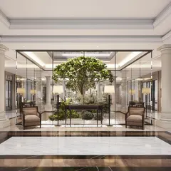 This neoclassical foyer is designed around a central courtyard, bringing a living tree into the heart of the home. The glass enclosure and classical columns frame the natural element, blending architecture with nature.