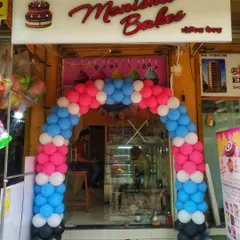 A colorful multi-layered balloon arch for the Manisha Bakes storefront. We use a mix of colors to create a fun and festive entrance for bakeries, cafes, and retail shops.