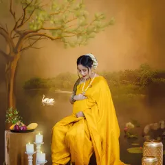 Inspired by the master painter Raja Ravi Varma, this portrait turns your maternity photo into a piece of fine art. The mom-to-be is styled in a traditional yellow saree.