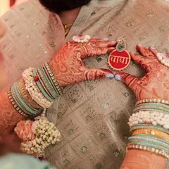 A special moment where the mom-to-be pins a custom 'Baba' brooch onto the father-to-be's outfit. I create these personalized floral brooches for parents-to-be.